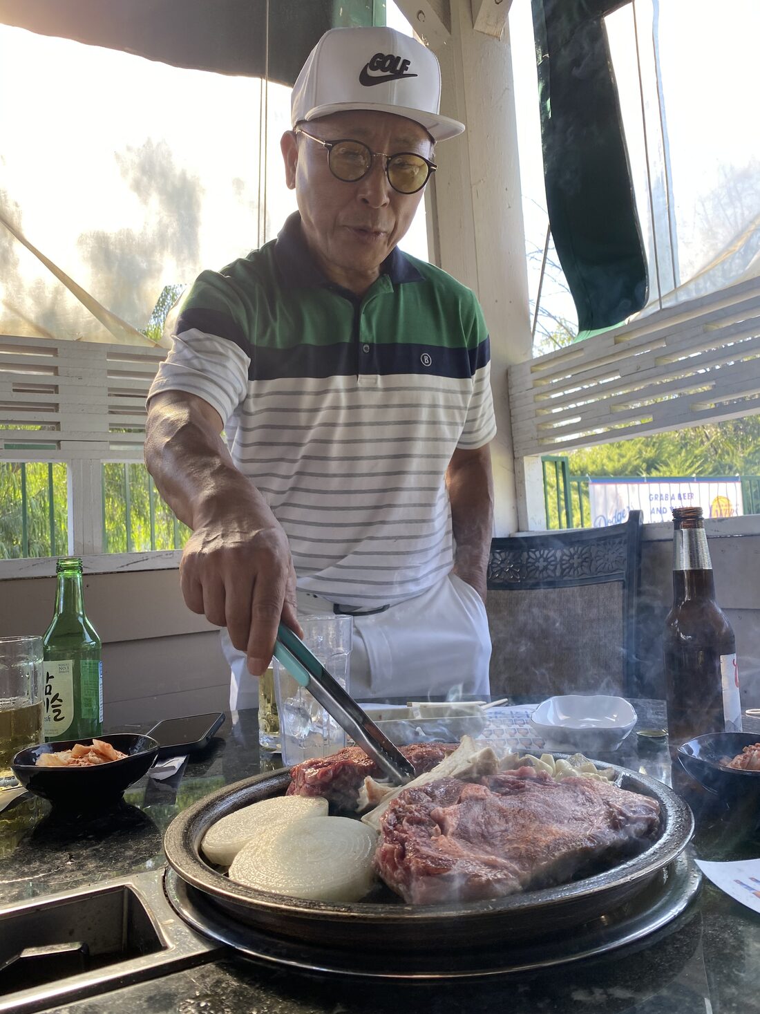 Owner John Mok working the grill on the patio