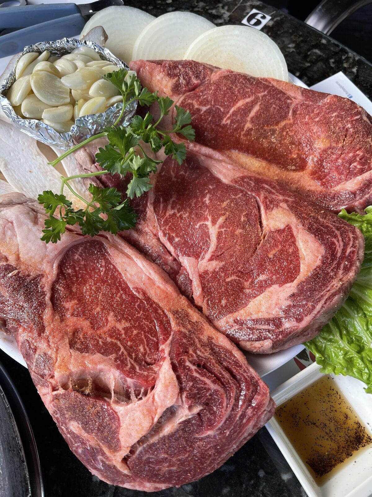 Ribeye ready for the grill, brought in for a booked celebration